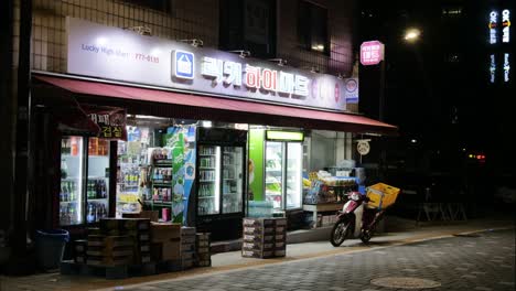 South-Korea-time-lapse-outside-busy-Asian-street-grocery-store-illuminated-at-night