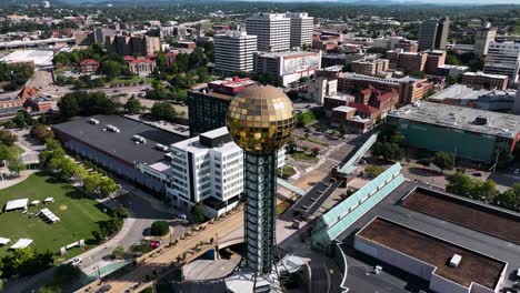 Aerial-view-over-the-mirroring-sphere-on-the-Sunsphere-tower,-in-Knoxville,-USA---reverse,-tilt,-drone-shot