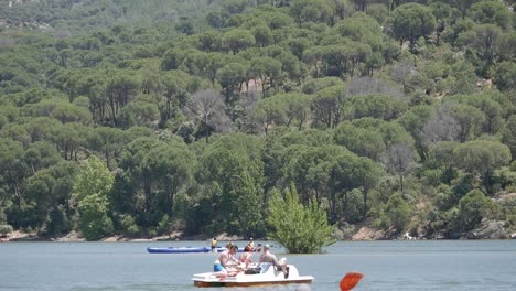 People-on-a-paddle-boat-paddling-along-reservoir
