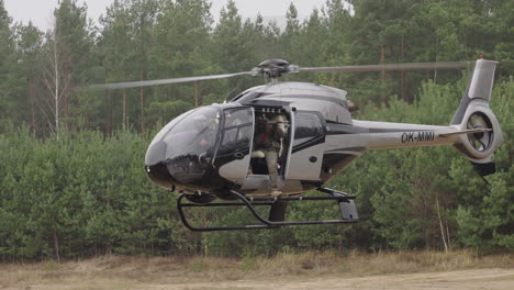 Police-and-Military-Special-Units-Training,-Soldier-Shooting-Target-From-Helicopter-Hovering-Above-Field