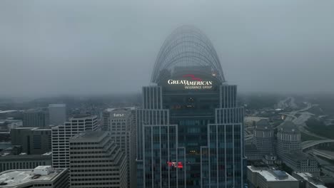 Aerial-view-through-fog,-around-the-Great-American-insurance-group-building-in-gloomy-Cincinnati,-USA---circling,-drone-shot
