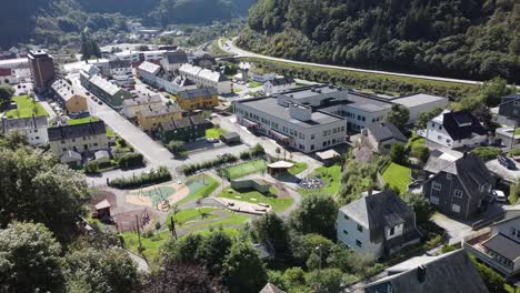 Brand-new-Dale-elementary-and-secondary-school-in-Vaksdal-municipality-Norway---Aerial-view-of-building-with-Dale-village-center-and-road-E16-in-background