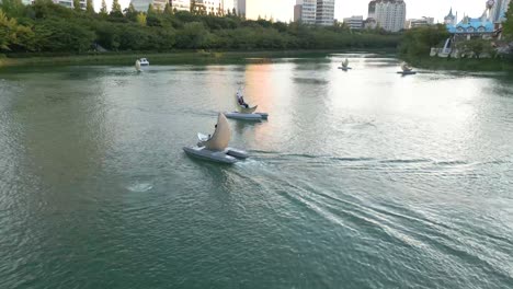 Drone-Shot-of-a-couple-riding-a-boat-on-Songpa-Naru-Park-in-Seoul,-South-Korea