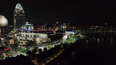 Aerial-view-over-the-illuminated-Great-American-Ball-Park,-nighttime-in-Cincinnati,-Ohio,-USA---rising,-drone-shot
