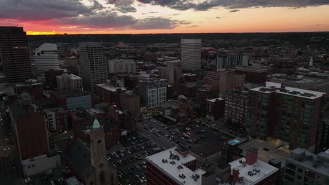 Aerial-view-overlooking-the-7th-street-in-downtown-Cincinnati,-colorful-dusk-in-Ohio,-USA---circling,-drone-shot
