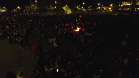 Aerial-view-of-women-burning-stuff-on-the-streets-of-a-city,-protesting-the-rise-of-hate-crimes-against-females-in-Mexico