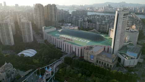 Toma-De-Drones-De-Lotte-World-Con-Parque-De-Diversiones-Al-Atardecer,-Seúl,-Corea-Del-Sur