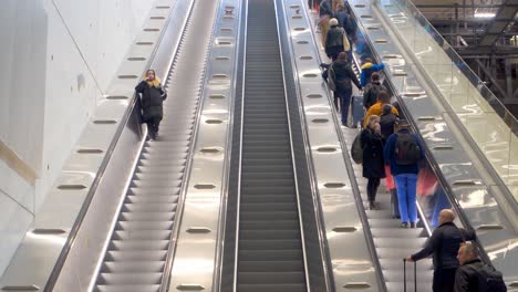 Close-up-of-people-on-escalator-in-Helsinki-Vantaa-Airport-,-Finland