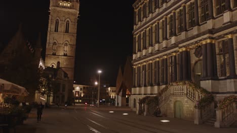 Beautiful-tilt-down-from-Belfry-to-facade-of-historical-city-hall-of-Ghent,-Belgium-at-Night
