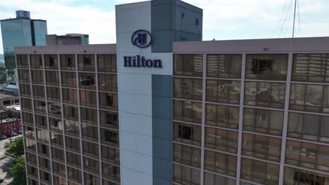 Vista-Aérea-Frente-Al-Logotipo-Del-Hotel-Hilton-En-El-Centro-De-Knoxville,-Ee.uu.---Descenso,-Inclinación,-Disparo-De-Drones