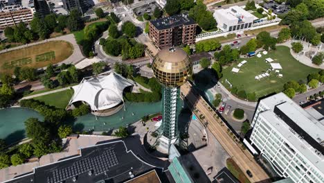Sunsphere-tower-in-sunny-Knoxville,-USA---high-angle,-circling,-tilt,-aerial-view