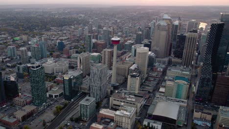 Aerial-view-around-the-Calgary-tower,-during-dusk-in-Alberta,-Canada---orbit,-drone-shot