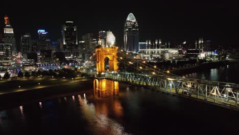 Aerial-view-around-the-Roebling-Bridge-with-Cincinnati-skyline-in-the-background,-evening-in-Ohio,-USA---circling,-drone-shot