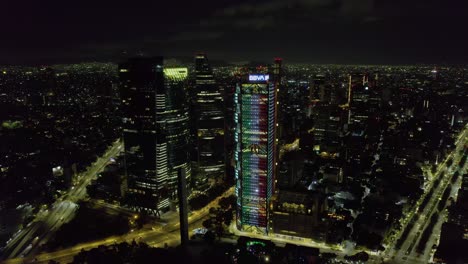 BBVA-building-and-Reforma-avenue,-Independence-day-night-in-Mexico-city---aerial-view