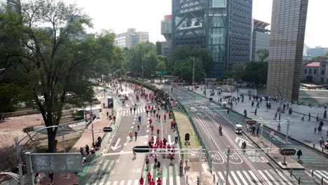 backwards-drone-shot-of-the-runners-of-the-city-marathon-as-they-pass-by-the-great-skyscrapers-of-the-city