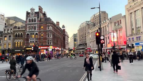 Tottenham-Court-Road-in-London-with-people-busy-shopping-and-commuting