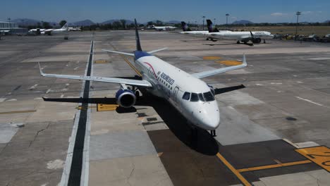 Aerial-view-around-a-Aeromexico-Boeing-757-200-airplane-at-a-airport---orbit,-drone-shot