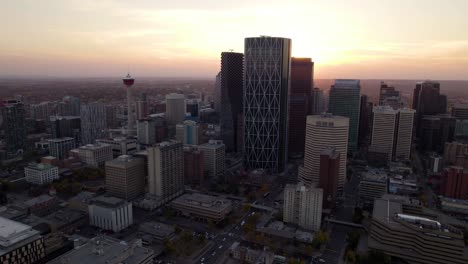 Aerial-view-towards-the-Calgary-skyline,-colorful-fall-dusk-in-Alberta,-Canada