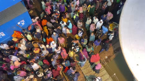 Crowd-of-people-waiting-and-passing-at-a-ship-terminal-station-in-Dhaka,-Bangladesh