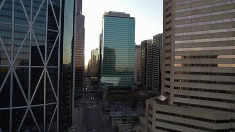 Aerial-view-in-middle-of-buildings-towards-the-TC-Energy-Tower,-sunset-in-downtown-Calgary,-Alberta,-Canada