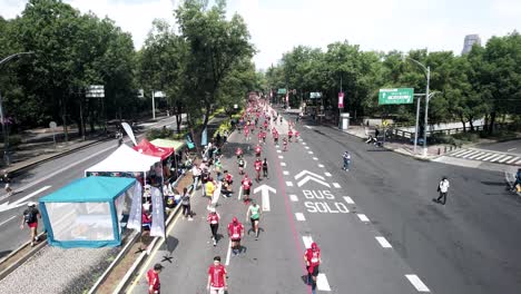 fixed-drone-shot-of-the-runners-of-the-city-marathon-as-they-pass-through-the-inner-circuit