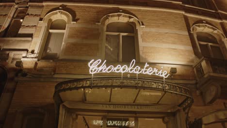 Artfully-crafting-light-sign-of-a-chocolate-shop-in-Belgium---wide