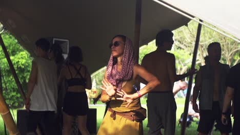 Latina-woman-wearing-hipster-clothing-and-dancing-ecstatically-during-live-music-festival,-filmed-in-super-slow-motion-as-medium-shot