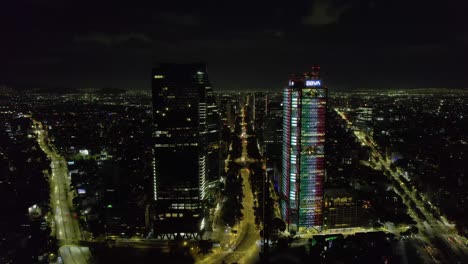 Aerial-view-towards-the-illuminated-Reforma-avenue,-Independence-day-night-in-Mexico-city