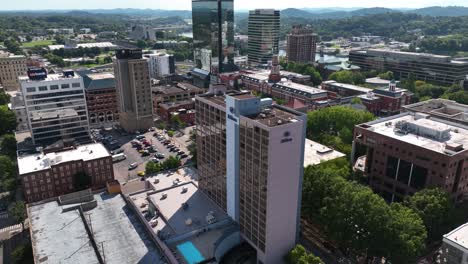 Aerial-view-away-from-the-Hilton-hotel-over-the-downtown,-sunny,-summer-day,-in-Knoxville,-USA---rotating,-pull-back,-drone-shot