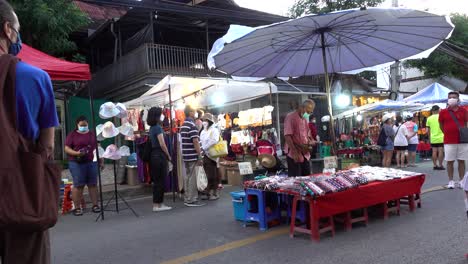 People-standing-still-as-National-Anthem-is-played-on-market-in-Thailand