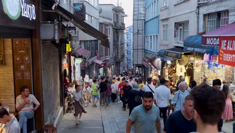 There-are-hundreds-of-diverse-people-walking-along-Istiklal-street,-one-of-the-most-popular-shopping-and-entertainment-places-during-weekends-in-Istanbul,-Turkey-09-July-2022