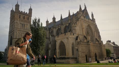 People-mingle-and-wander-around-the-historic-and-ornate-Cathedral-Church-of-Saint-Peter-in-Exeter,-Devon,-UK-on-a-busy-Saturday-afternoon-in-early-autumn