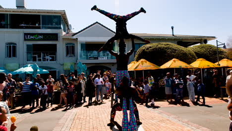 Street-performers-performing-for-crowd-during-Whale-Festival,-Hermanus