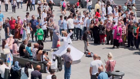 With-crowds-of-people-near-Galata-Bridge,-Istanbul,-Turkey,-Sufi-dance-performanceon-09-July-2022