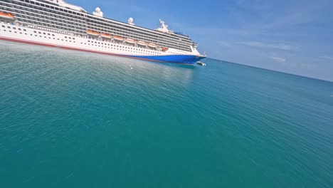 Aerial-racing-drone-fpv-flying-over-moored-cruise-ship-and-Amber-Cove-tourist-village,-Puerto-Plata-in-Dominican-Republic