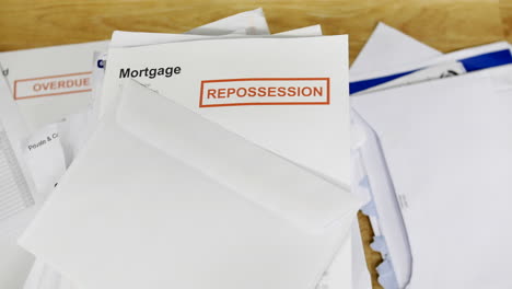 A-stack-of-bills-and-debts-with-a-mortgage-repossession-notice-letter