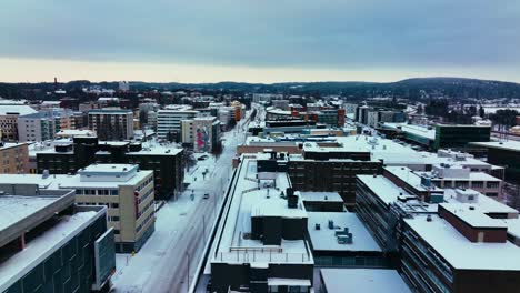 Aerial-view-over-the-streets-in-Jyvaskyla-gloomy,-winter-evening-in-middle-Finland---tracking,-drone-shot