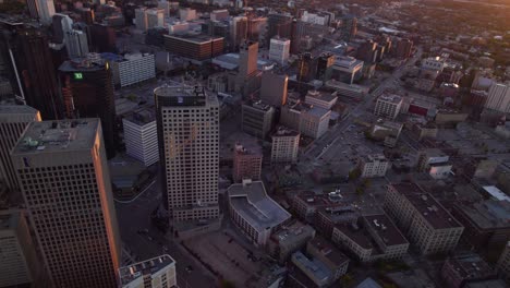 Aerial-view-overlooking-the-sunlit-cityscape-of-Winnipeg,-fall-evening-in-central-Canada---panoramic,-drone-shot