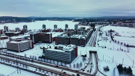 Aerial-view-around-the-Lutakko-area-in-Jyvaskyla,-winter-evening-in-Finland---circling,-drone-shot