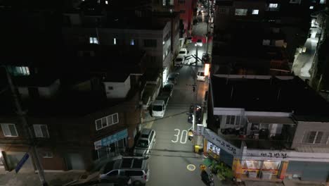 Flying-over-Daegu-city-Seoul-Korea-neighbourhood-alleyway-at-night-aerial-view