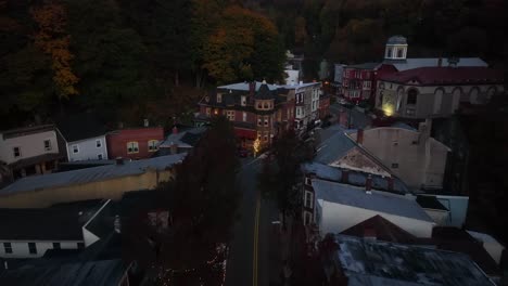 Aerial-pullback-reveal-of-quaint-village-with-Victorian-architecture-at-night