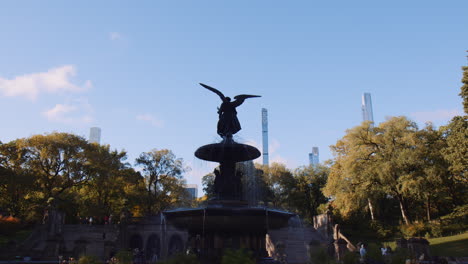 Angel-of-Waters-Statue-at-Bethesda-Terrace-Fountain,-Urban-Architectural-Monument-Art-Overlooking-Central-Park,-New-York-City-Manhattan,-Trees-and-Skyscrapers-Towers-in-Background