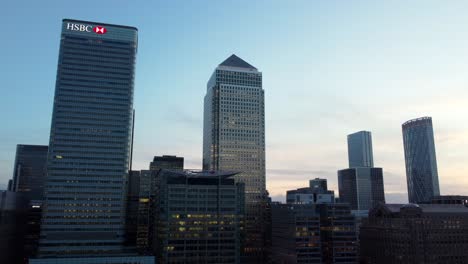 Cinematic-drone-shot-orbiting-HSBC-and-One-Canada-Square-skyscrapers,-London