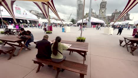 shot-of-couple-sitting-reading-the-newspaper-in-the-zocalo-of-mexico-city-in-the-morning