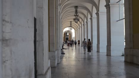 People-walk-through-the-magnificent-archway-building-in-praça-do-comércio