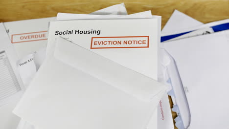 A-pile-of-bills-and-letters-with-an-eviction-notice-for-social-housing