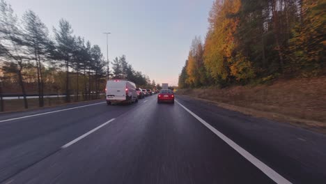 Highway-driving-POV:-Bumper-to-bumper-vehicles-on-fall-morning-commute