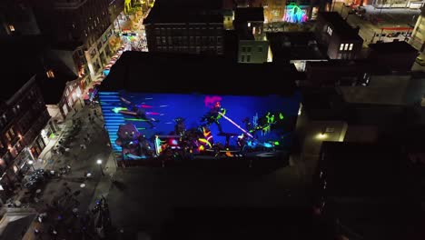 Aerial-view-around-a-Illuminated,-holographic-LED-Mural-wall,-at-BLINK-the-festival-of-light-and-art-in-Cincinnati,-Ohio,-USA