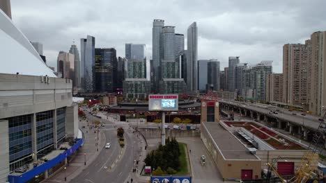 Aerial-view-towards-the-Rogers-centre-sign-in-downtown-Toronto,-cloudy,-fall-day-in-Ontario,-Canada