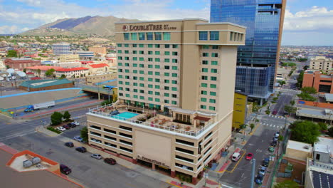 Aerial-Drone-Establishing-Shot-of-DoubleTree-by-Hilton-Hotel-Building-in-Downtown-El-Paso-TX-Area-Next-to-I-10-Freeway